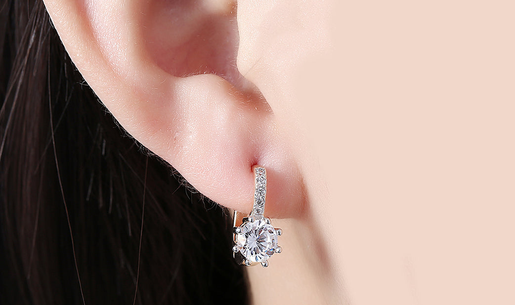 White Topaz 0.70 CT Round Huggie Earring in  Silvertone